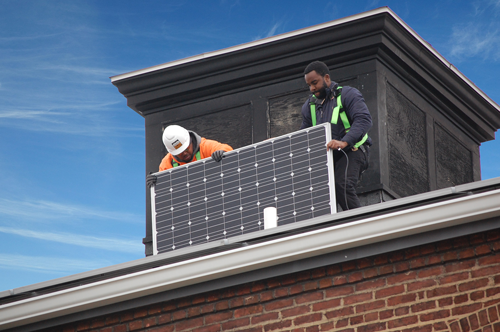 Panels-going-on-to-roof-of-POWER-House-Web