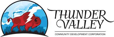 Logo for Thunder Valley Community Development Corporation featuring a red bison with a white lightning bolt and blue sky background.